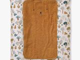 a brown towel sitting on top of a pillow covered in animal print