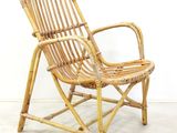 a wicker chair that is sitting on a concrete floor