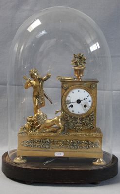 a gold clock under a glass dome on a table