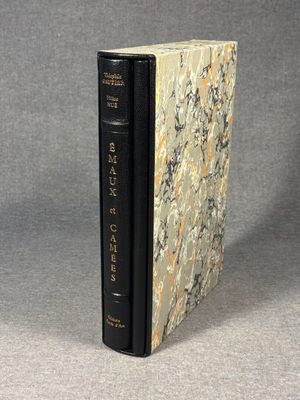 an old book sitting on top of a table next to a gray background