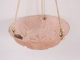 pink glass hanging bowl with rope hanging from it ' s side