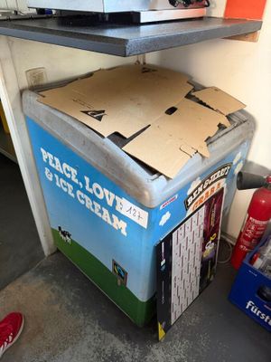 a box of ice cream sitting on top of a refrigerator