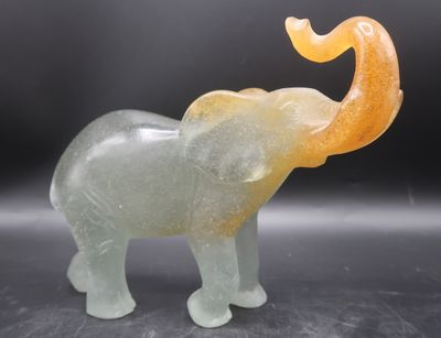 an elephant that is standing on a black surface