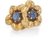 une image représentant une bague en pierre dorée et bleue sur fond blanc
