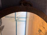 a bathroom with a sink and a mirror with a bird on it