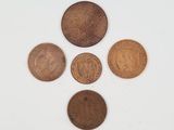 five different coins are arranged in a circle on a white surface