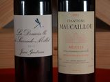 two bottles of wine sitting next to each other on a table