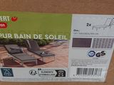 a box with a pair of lounge chairs in it