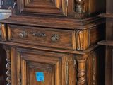 two wooden cabinets that are stacked on top of each other