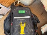 a backpack and a pair of shoes sitting on the floor