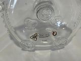 a glass vase with a clock inside of it on a table