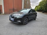 a black nissan qx parked in front of a building