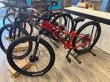 two bikes are parked in a bike shop on a wooden floor