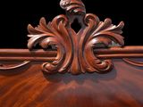 a wooden bed with a carved headboard and foot board