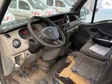 a dirty car inside of a building with a steering wheel