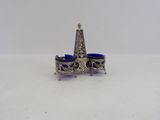 an image of a silver and blue glass candle holder on a white surface