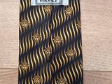 a black and gold tie with a black label on it