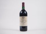 une bouteille de vin posée sur une table blanche