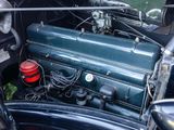 a close up of an old car engine with a red cap