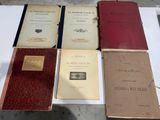 several old books are sitting on a table on a table