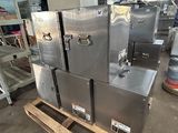 several stainless steel appliances are stacked on pallets in a warehouse