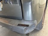 a close up of a car ' s bumper with a hole in it