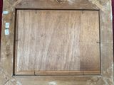 an old wooden picture frame with a picture hanging on it