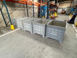 three containers that are sitting on the floor in a warehouse
