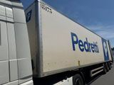 two semi trucks parked side by side in a parking lot