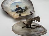 a shell with a picture of a man and a bird on it