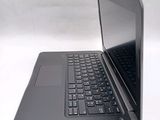 a laptop computer sitting on a table with a keyboard on it