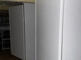 an image of a white refrigerator in a dirty room