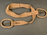 two pieces of cloth with a metal buckle on a gray surface