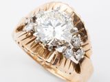 a close up of a diamond ring on a white surface