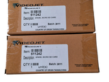 pair of two boxes with labels on them sitting on a white surface