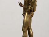 bronze statue of a man with a backpack standing on a table