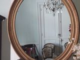 a mirror that is sitting on a dresser in a room