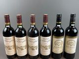 six bottles of wine lined up in a row on a table
