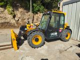 a picture of a construction vehicle parked in front of a building