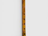 a wooden flute on a white background