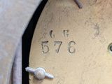 a close up of a metal clock with numbers on it