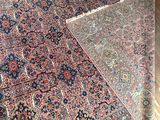 a large rug on the floor next to a chair
