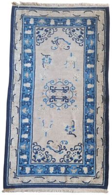 a blue and white rug with an oriental design on it