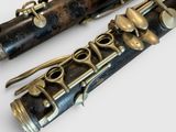 two clarinets that are sitting side by side on a white surface