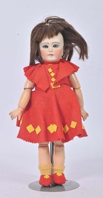 a doll that is wearing a red dress and yellow socks