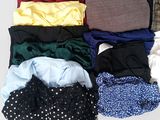 a lot of clothes that are laying out on a table