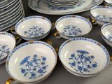 a lot of plates and cups that are on the table