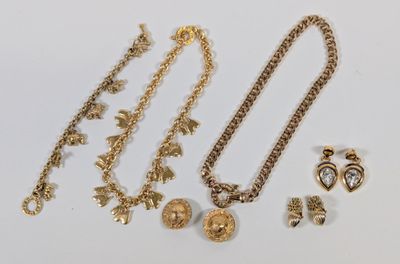 a close up of a bunch of jewelry on a white surface