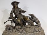 bronze statue of a man on a horse with a dog