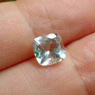 une personne tenant un diamant vert et blanc dans la main